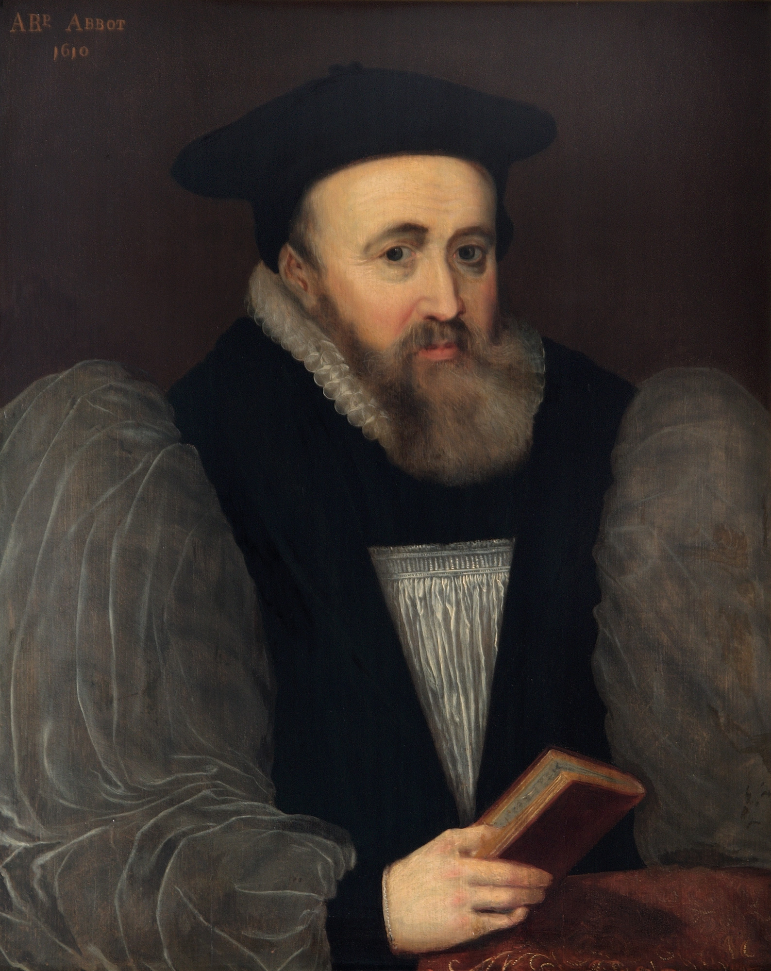 Painted portrait of a man, with a grey beard velvet coat and puffy sleeves, holding a book in one hand.