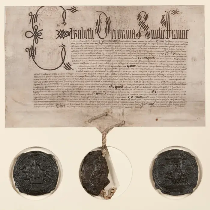 Charter with elaborate heading and three round grey seals below.