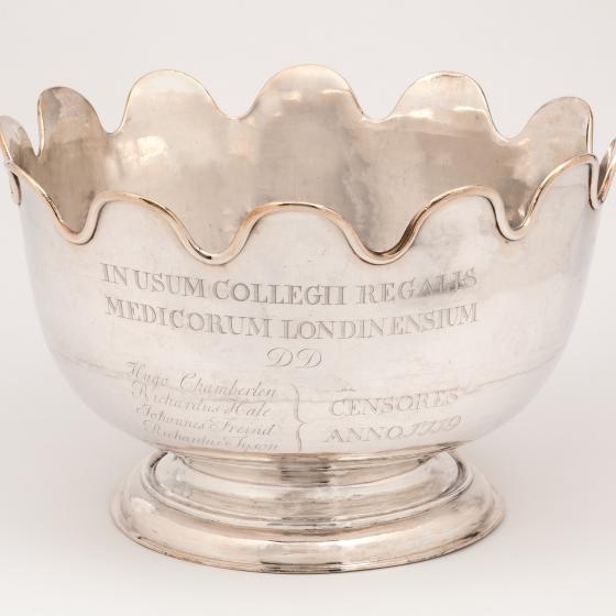 Image of a silver bowl with scalloped edge, text on the front. Image of a silver bowl with scalloped edge, text on the front.