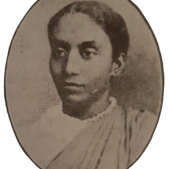 Sepia toned oval photograph portrait of a woman, looking slightly to the left. What is visible of her clothing appears to be a pale blouse under pleated fabric over her right shoulder. Sepia toned oval photograph portrait of a woman, looking slightly to the left. What is visible of her clothing appears to be a pale blouse under pleated fabric over her right shoulder.
